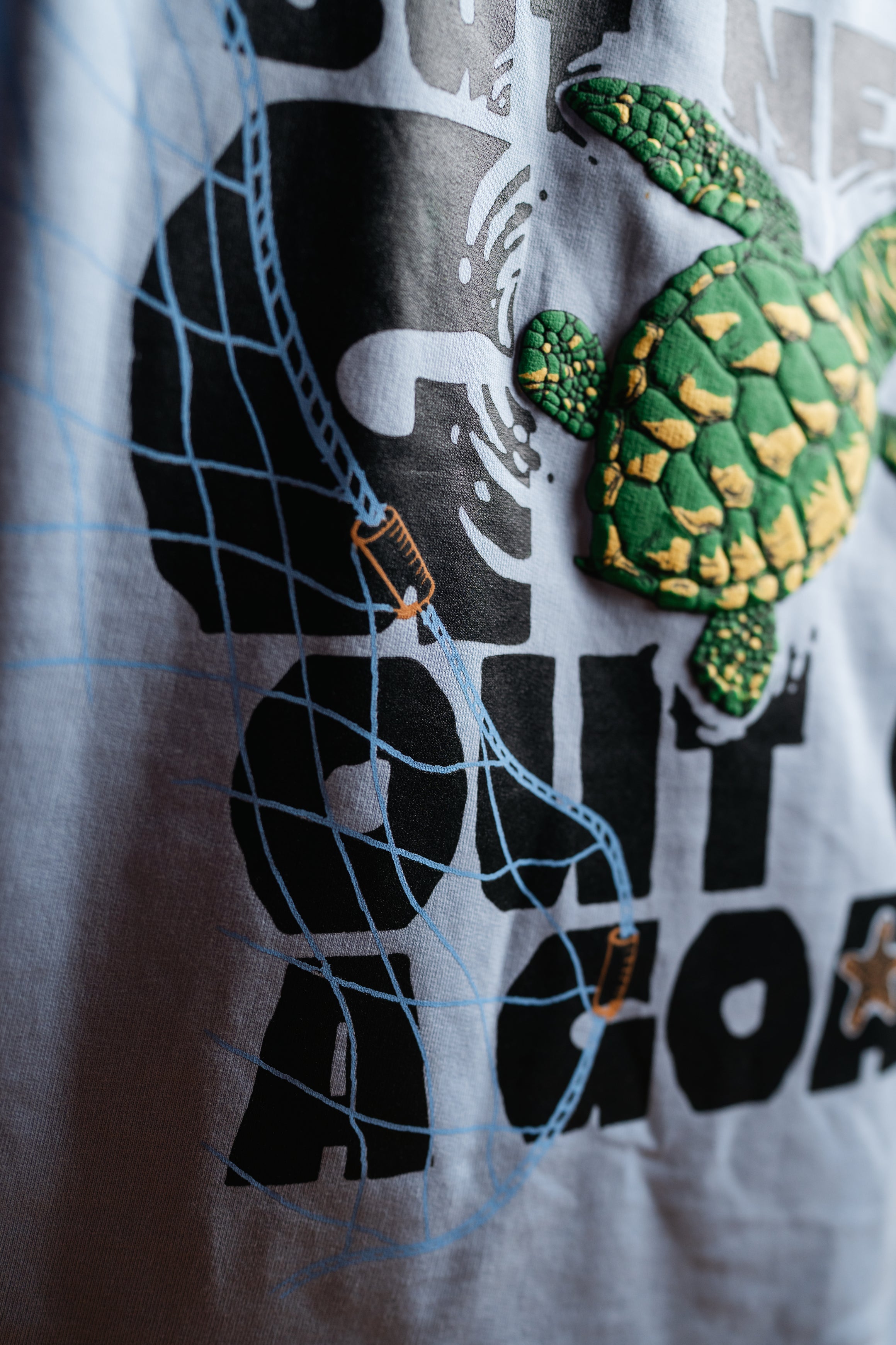 T-shirt with a turtle design and text on a white background