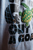 T-shirt with a turtle design and text on a white background