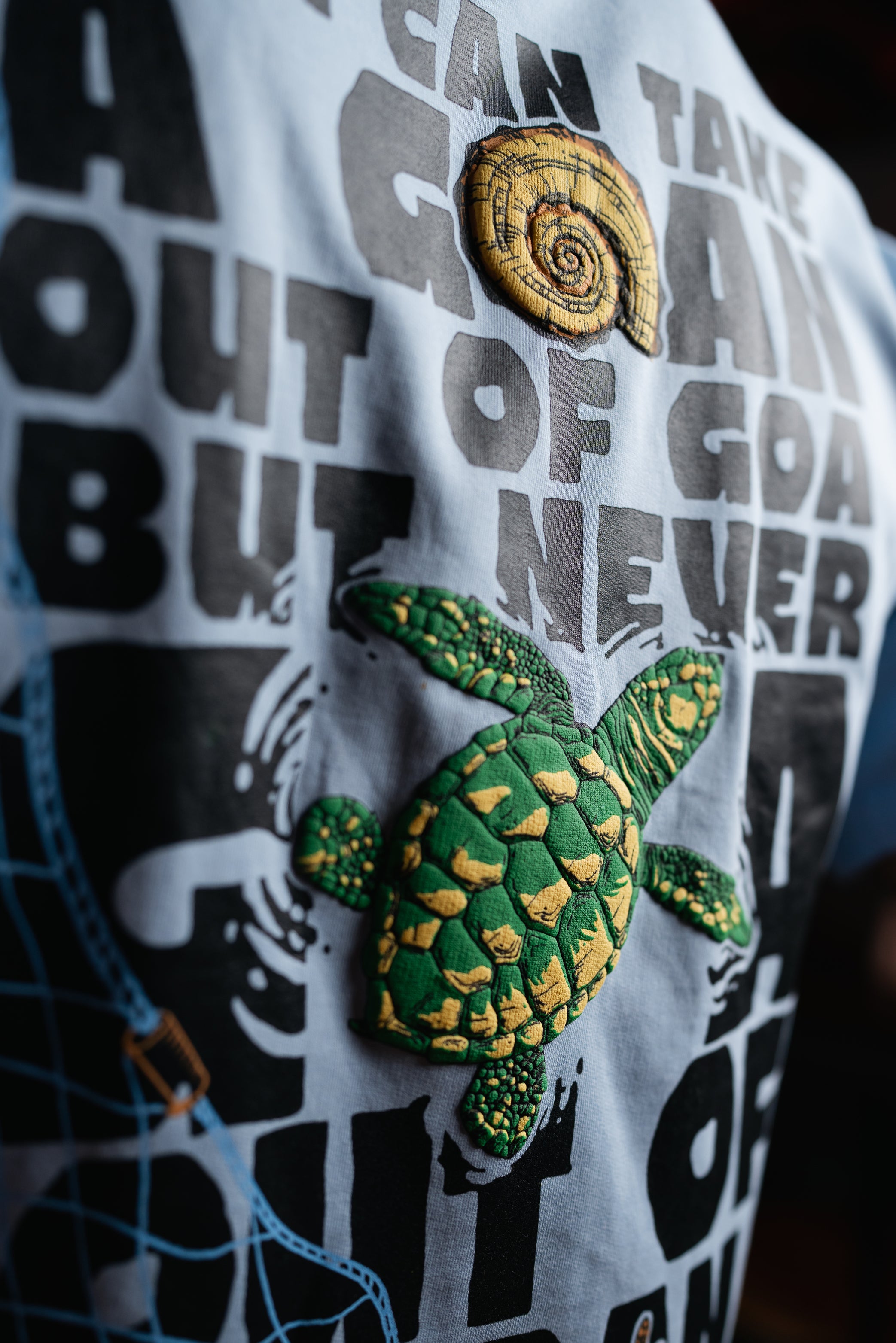 T-shirt with turtle design and text on a white background